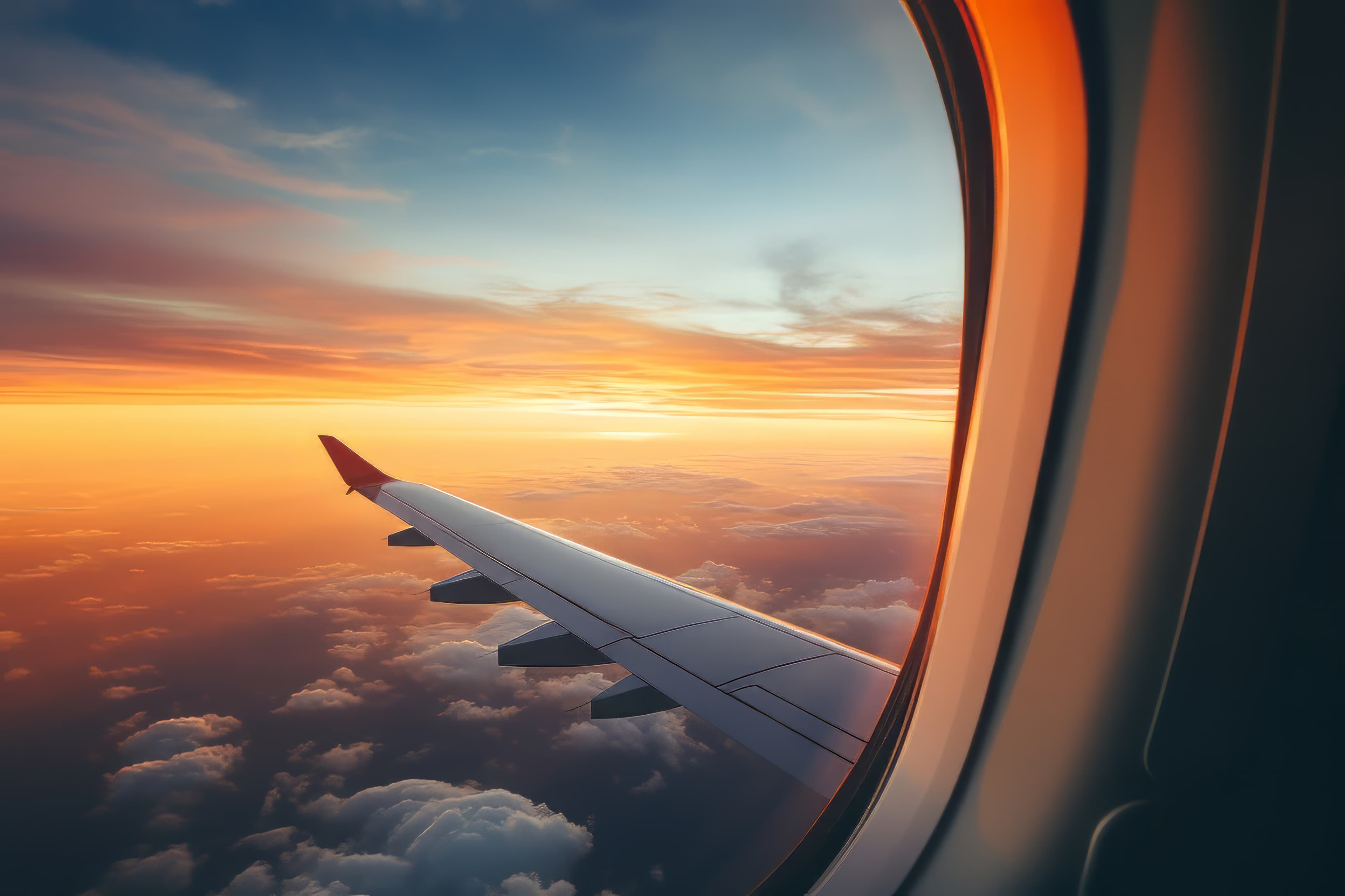 Airplane wing during sunset flight